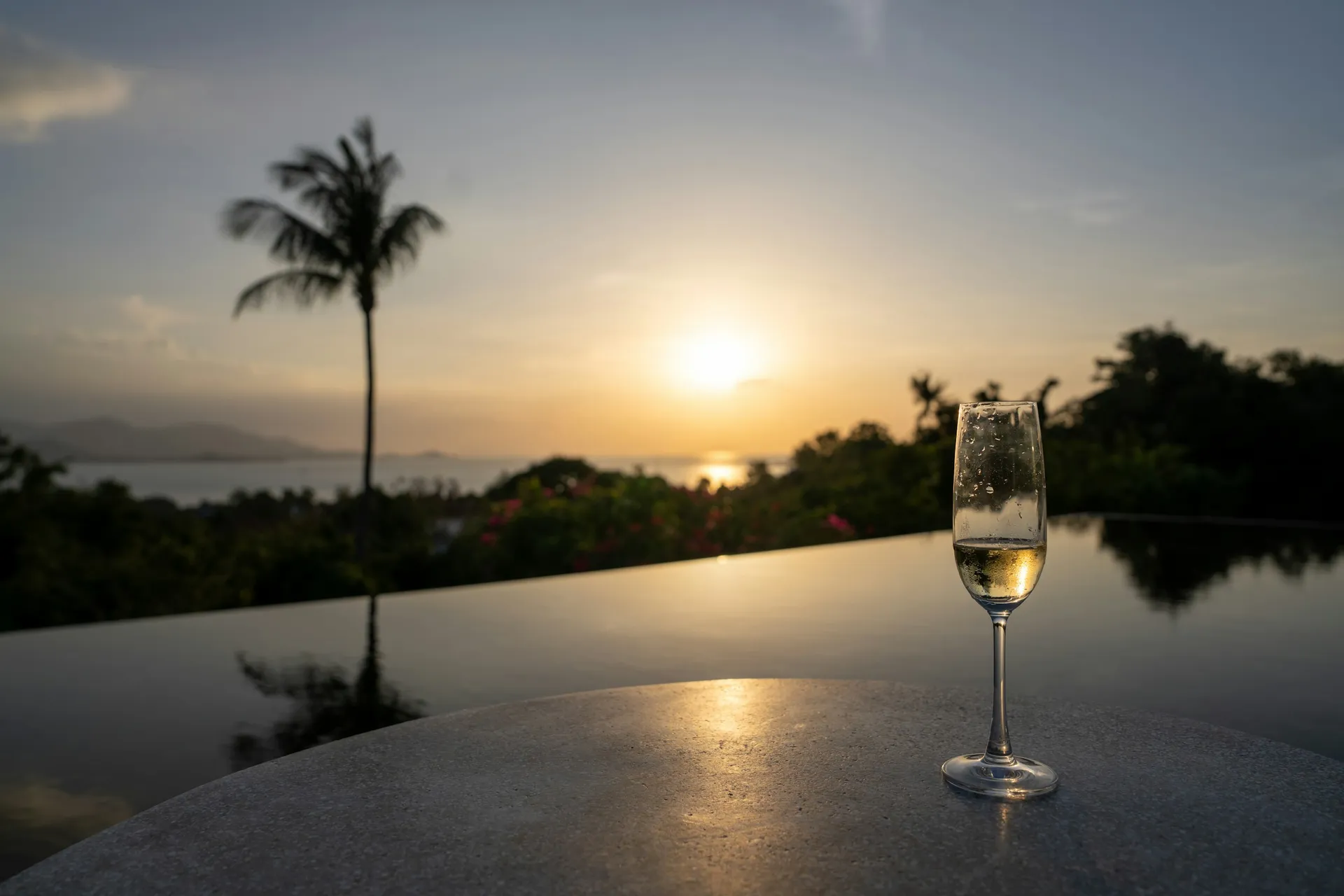 A glass of champagne at sunset overlooking the sea