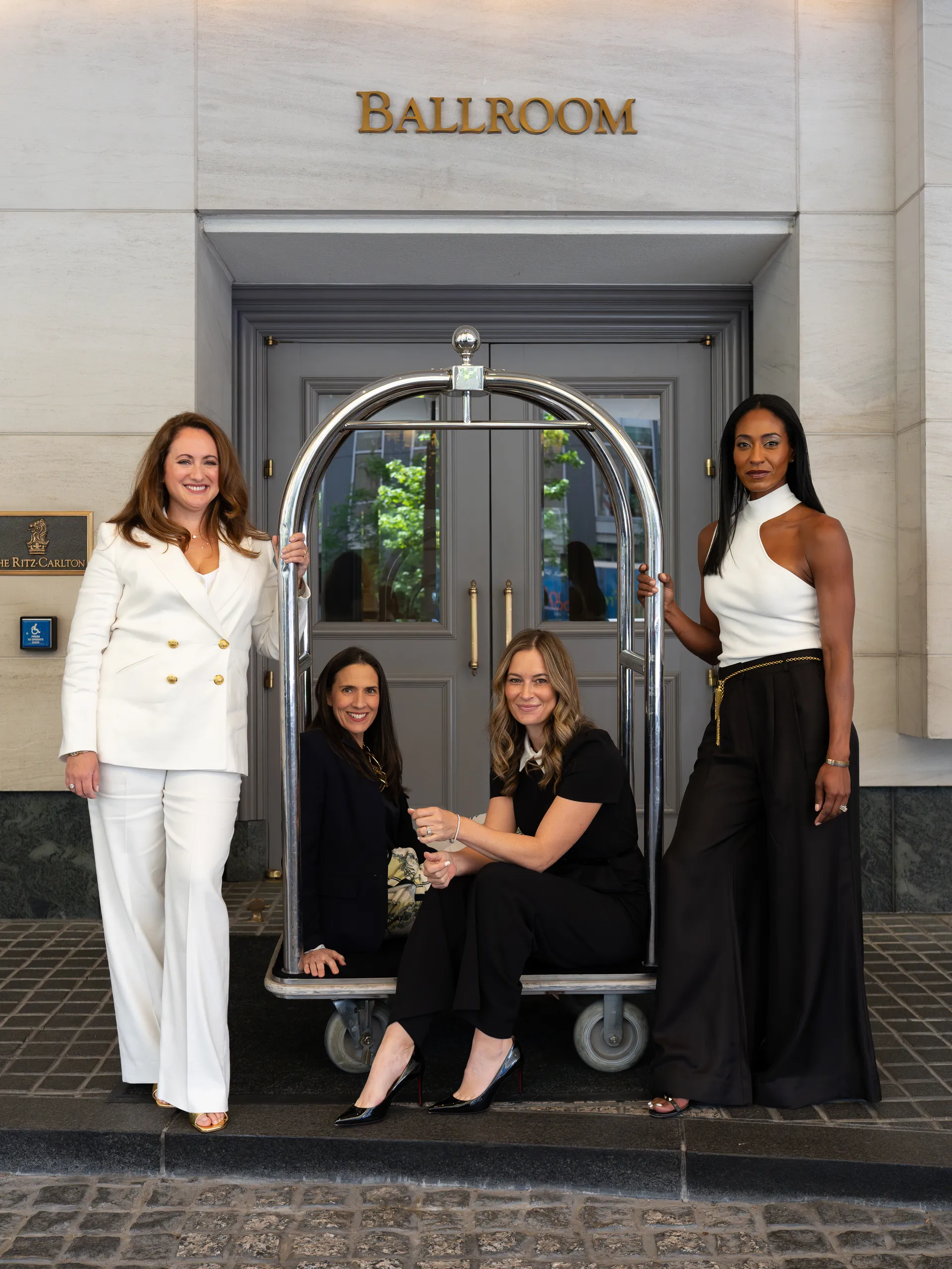 The four Next ChaptHER co-founders at the ballroom entrance of The Ritz-Carlton